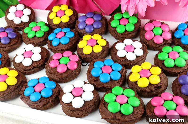 Beautiful chocolate cookies adorned with colorful M&M flowers, displayed on a serving platter.