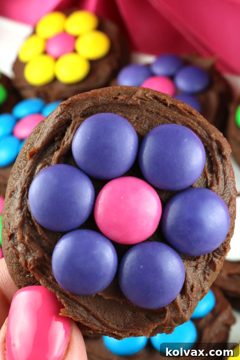 Close-up shot of a single decorated chocolate M&M flower cookie, showcasing its vibrant colors and delicious texture.
