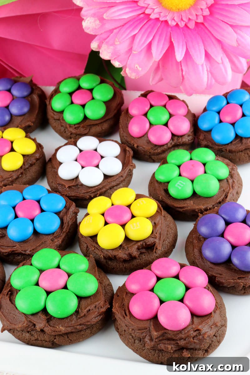 Several M&M flower cookies arranged artfully on a white surface, ready to be enjoyed.