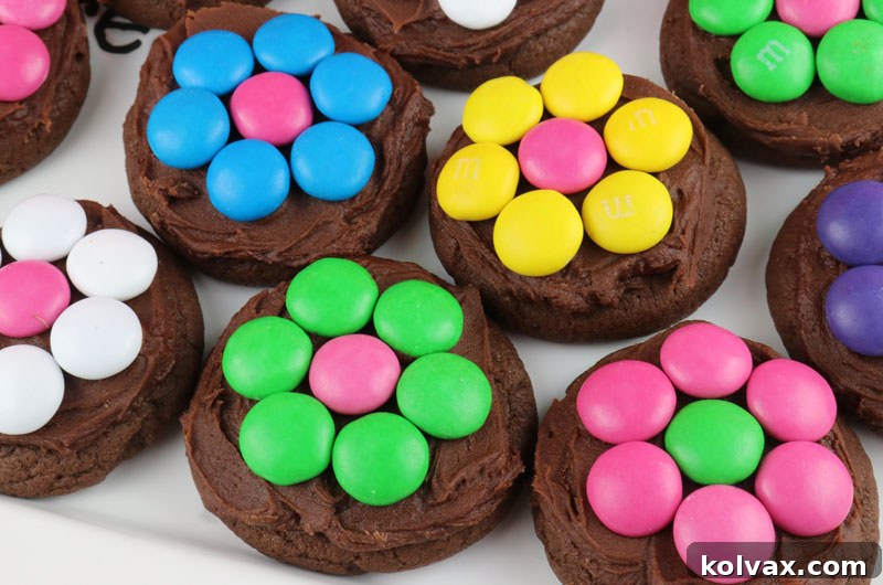 A collection of vibrant chocolate cookies, each topped with a unique M&M flower design.