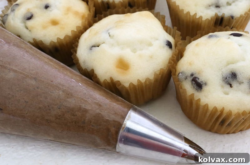 A bowl of freshly made Mocha Whipped Cream Frosting, showcasing its smooth, light texture and enticing color.