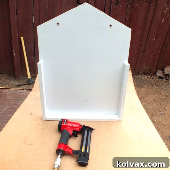 Attaching the assembled edge frame to the main plywood sled base