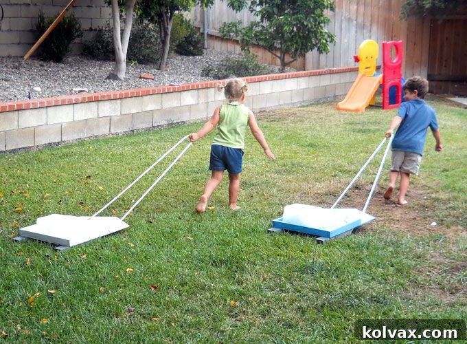 Children participating in the Frozen Ice Block Races, pulling ice on their DIY sleds