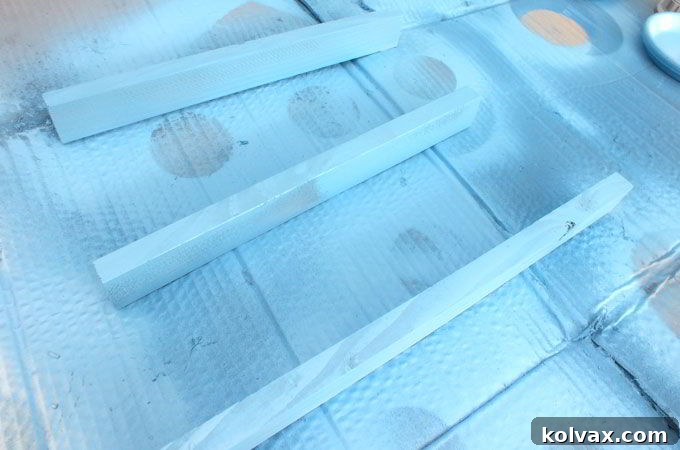 Cutting and painting the 1x2 wood pieces for the sled side and back edges