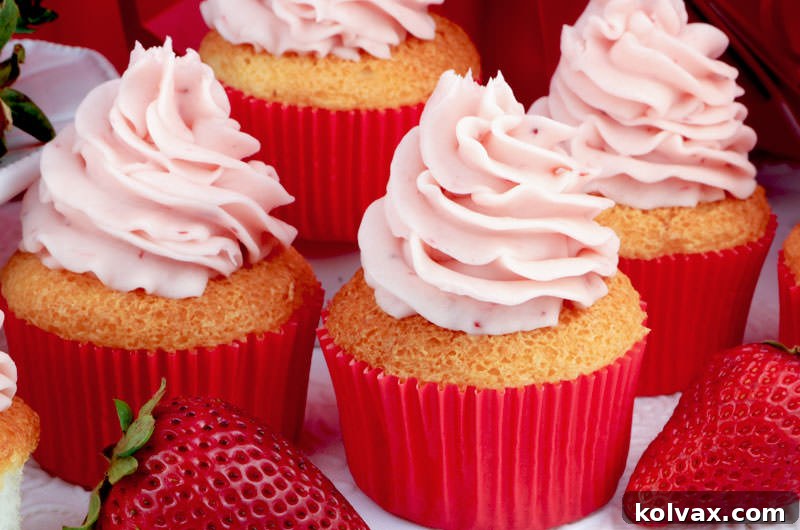 Light and airy Angel Food Cupcakes topped with sweet, tangy Strawberry Buttercream Frosting, perfect for summer gatherings and BBQs.