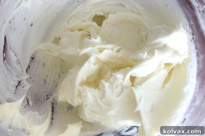 Adding peppermint extract to fluffy buttercream frosting for a refreshing mint flavor.