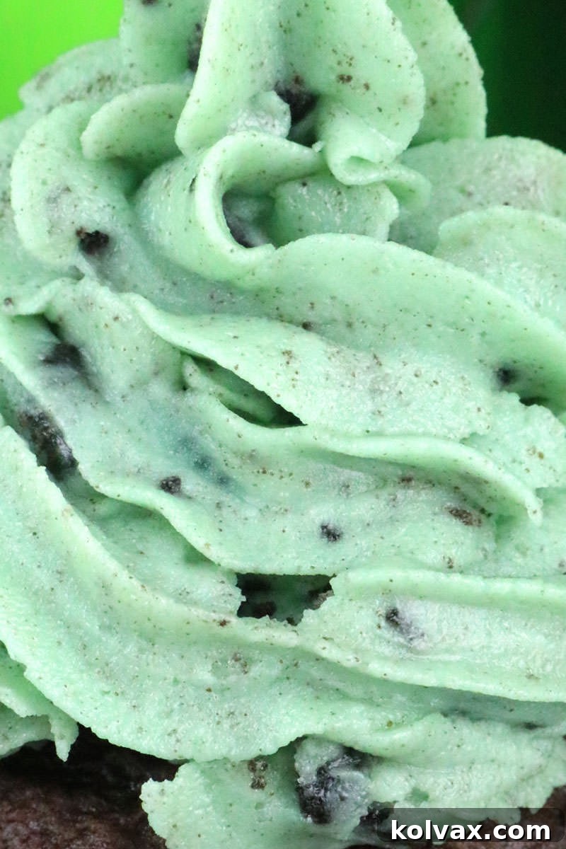 Mint Oreo Buttercream Frosting on a delightful cupcake, garnished with additional Oreo crumbs, ready to be served.