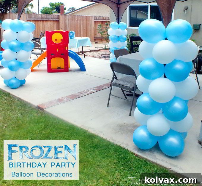 Frozen themed party decorations with balloon columns and festive setup