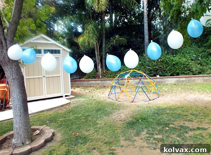 Making an easy balloon banner by taping balloons to a ribbon for party decor