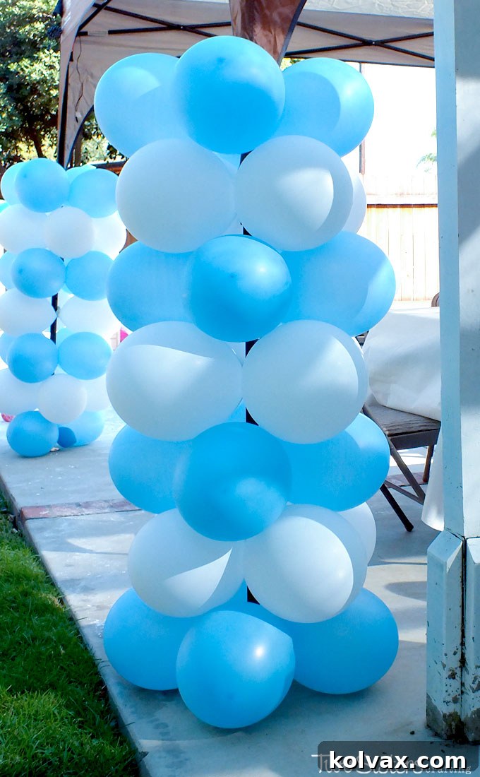 Beautiful Disney Frozen balloon decorations for a party, featuring columns and banners