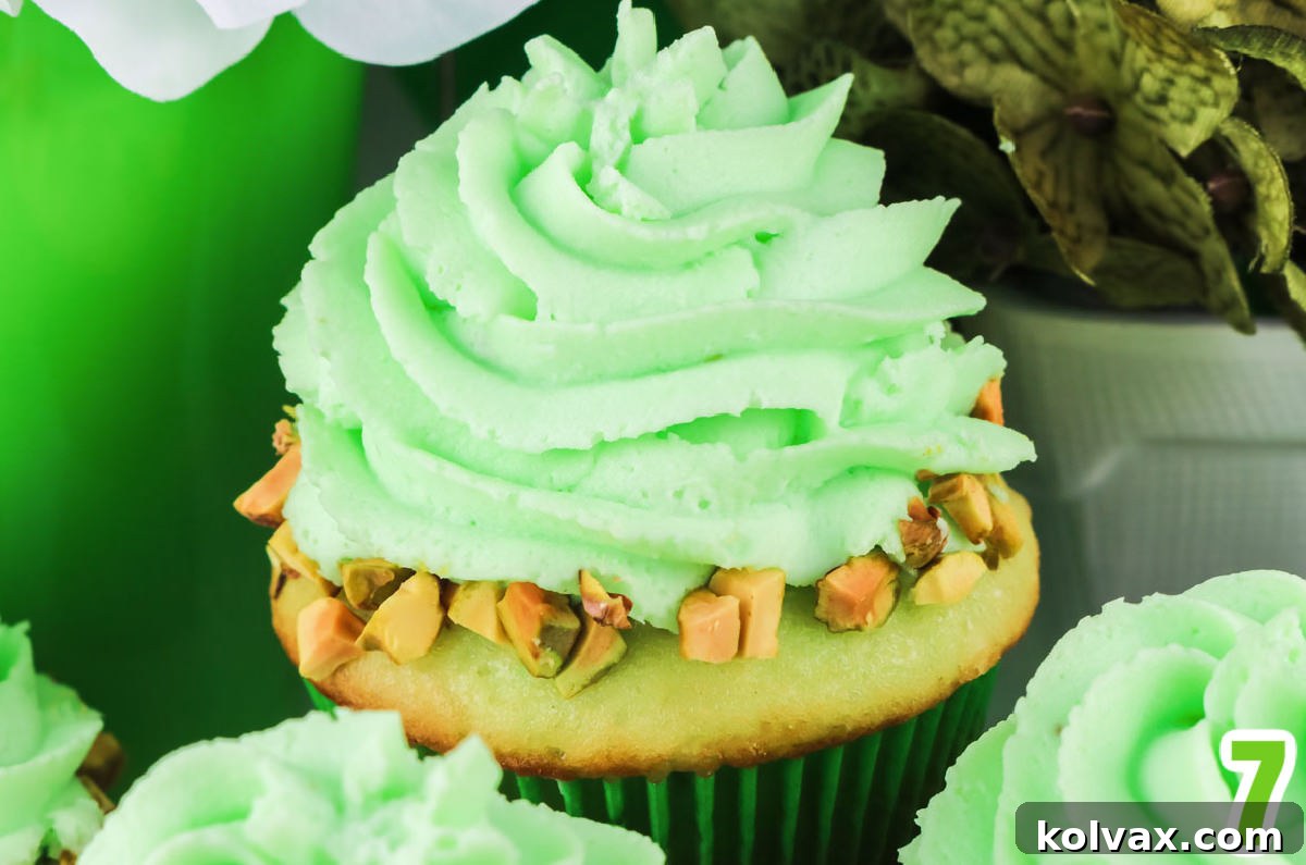 Close-up of a perfectly swirled Pistachio Whipped Cream Frosting on top of a Pistachio Cupcake.