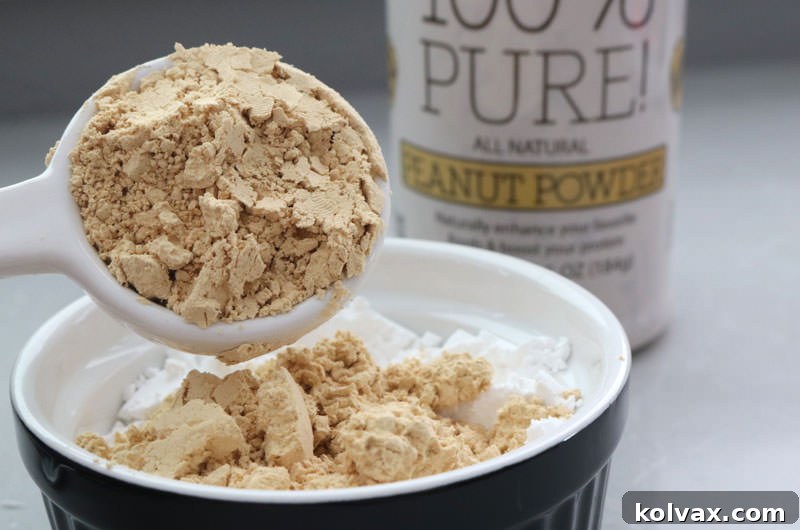 Close-up of Peanut Powder, a key ingredient for achieving rich peanut butter flavor in whipped cream frosting without compromising its light texture. Shows the fine, uniform consistency of the powder.