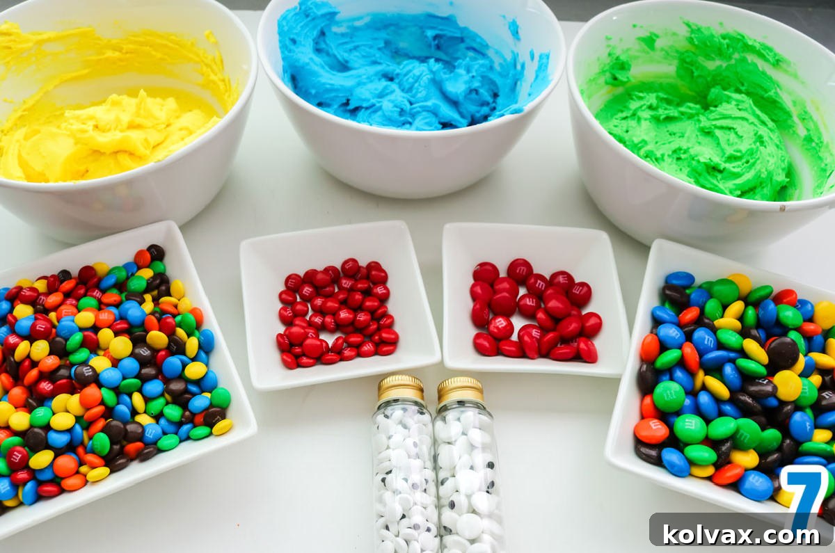 A beautifully arranged white table showcasing bowls brimming with various colored frostings and an assortment of M&M's, ready for cookie decorating.