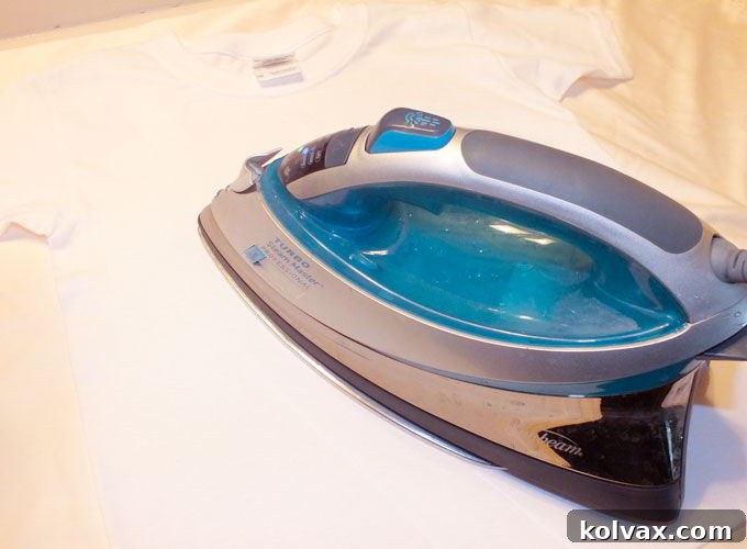 Using iron to transfer Olaf image to the T-Shirt