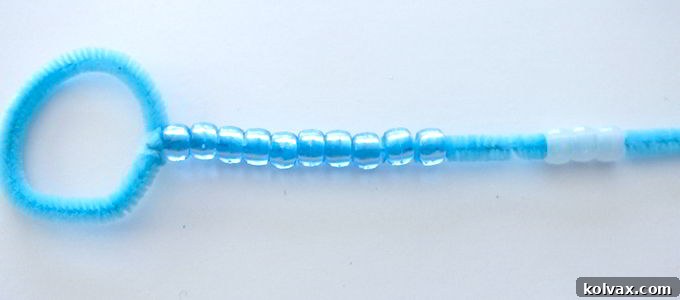 Thread an array of colorful plastic pony beads onto the pipe cleaner body of your DIY Bubble Wand, creating a vibrant and personalized design.