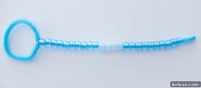 Ensure stability and a comfortable grip for your DIY Bubble Wand by leaving approximately 3/4 inch of the pipe cleaner free of beads at the handle end.