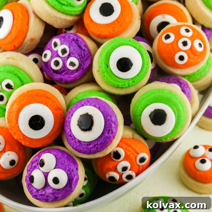 Delicious Mini Monster Sugar Cookies, a fun Halloween frosted sugar cookie with buttercream frosting and Monster Candy Eyes, perfect for parties.