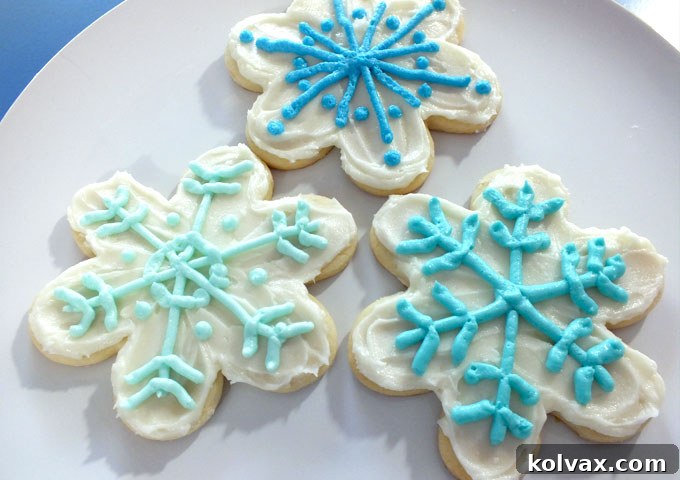 Delicious frosted sugar cookies shaped like snowflakes, perfect for a Disney Frozen themed party. Learn how to make these delightful treats with our best sugar cookie and buttercream frosting recipes.
