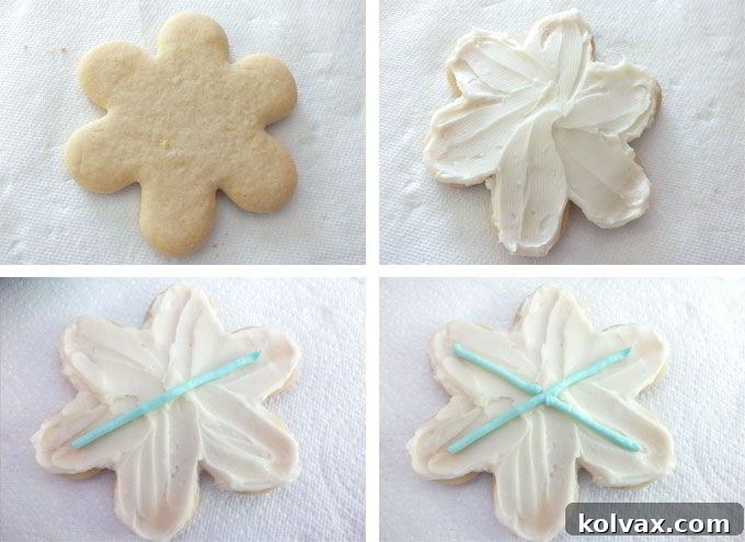 The first step in decorating Frozen Snowflake Cookies: applying a smooth, white buttercream base layer.