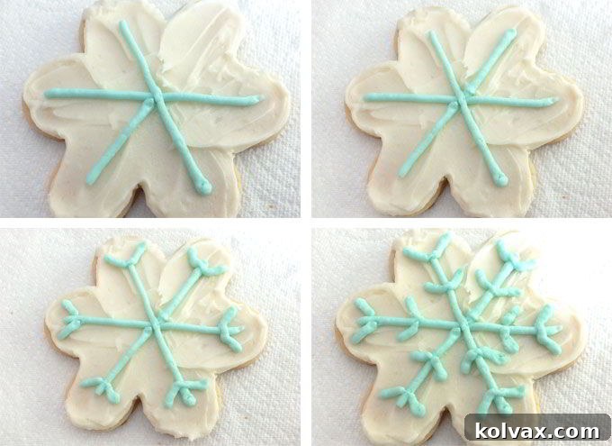 The second step in decorating Frozen Snowflake Cookies: Nancy expertly pipes intricate snowflake designs with colored buttercream.
