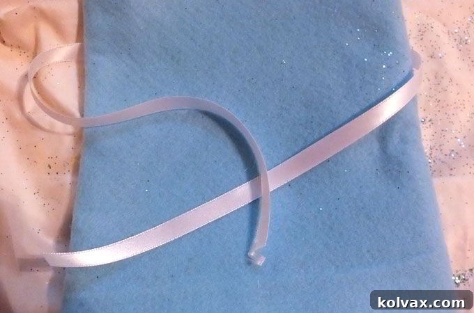 Tie piece of satin ribbon around the Elsa Party Favor Bag