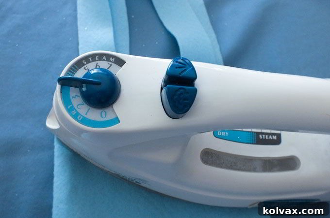 Attaching the iron on letters to the Party Favor Bag