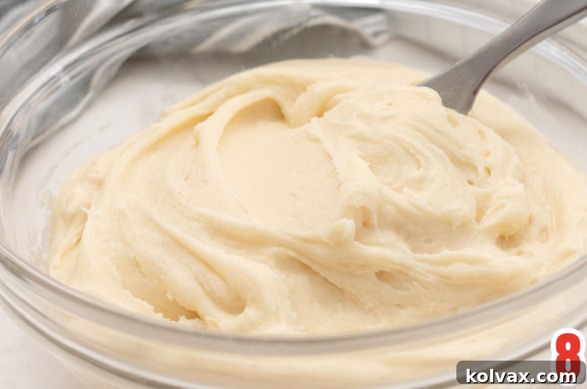 Closeup on a glass bowl filled with homemade Cream Cheese Frosting.