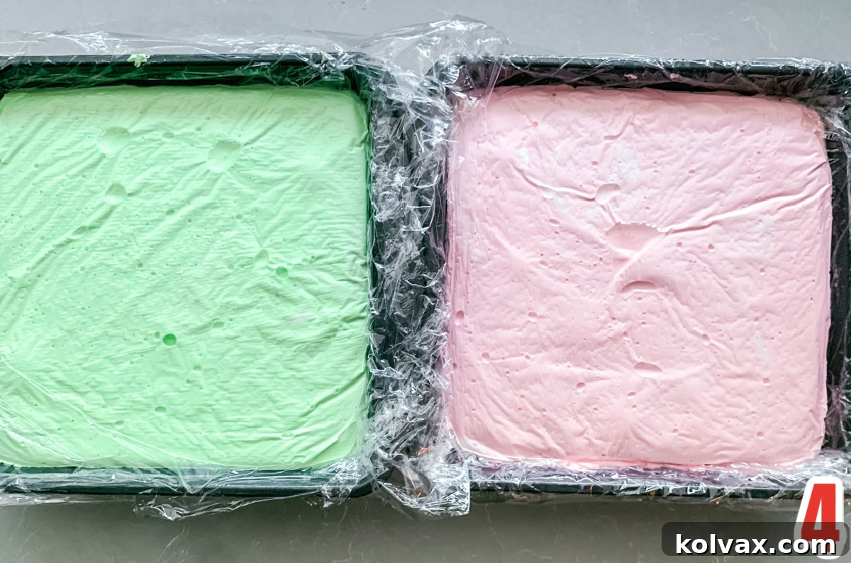 Overhead shot of two 8x8" pans filled with Green and Red Marshmallow mixture.