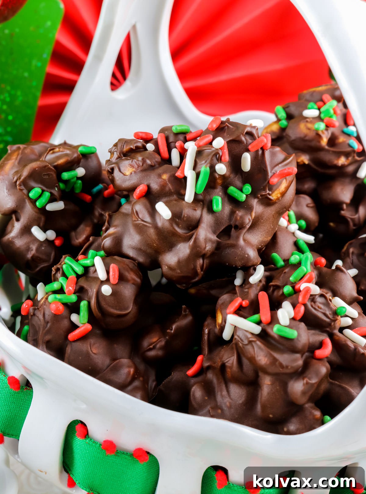 Closeup on a white serving bowl filled with Chocolate Peanut Clusters.