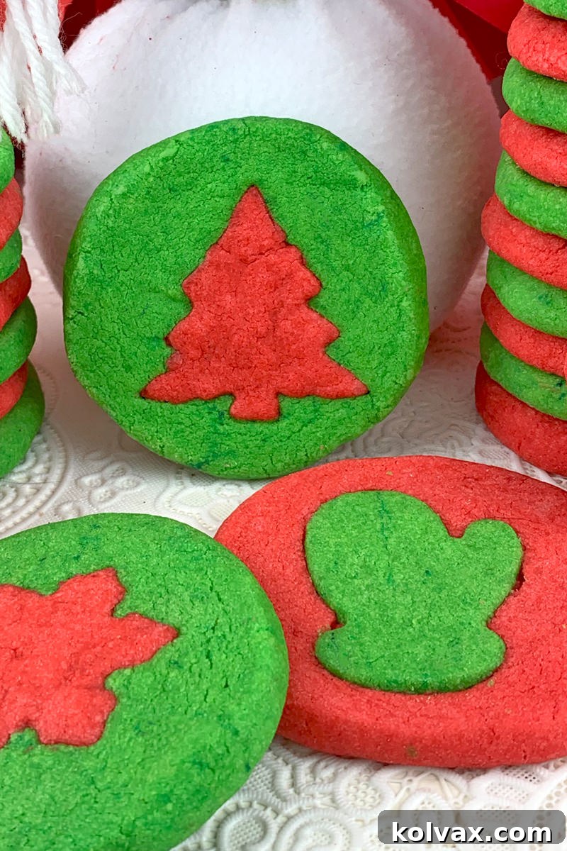 A close-up of a festive plate filled with colorful red and green Holiday Butter Cookies, perfect for sharing.