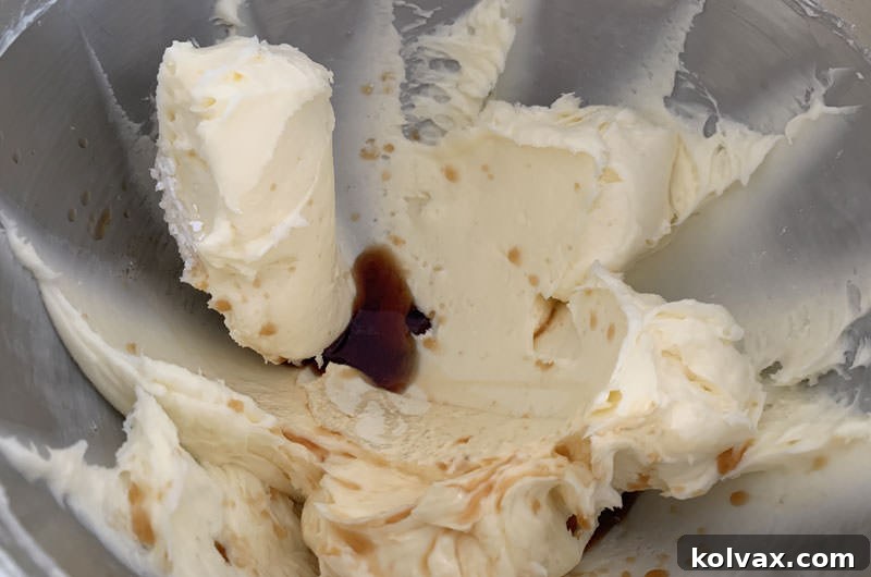 Mixing bowl with creamed butter and powdered sugar, now light and fluffy.