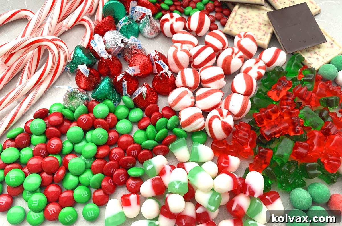 A delightful collection of assorted Christmas candies, thoughtfully arranged on a sleek gray table, ready to adorn any holiday dessert board.