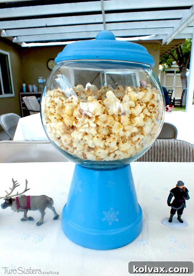 Beautiful Disney Frozen Centerpieces, resembling bubble gum machines and filled with popcorn, served as a big hit at our Frozen Birthday Party for adults and kids alike.