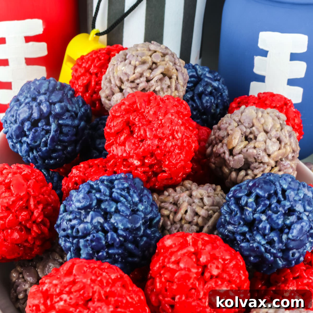 Closeup on a batch of Houston Texans Rice Krispie Bites surrounded by football decorations.