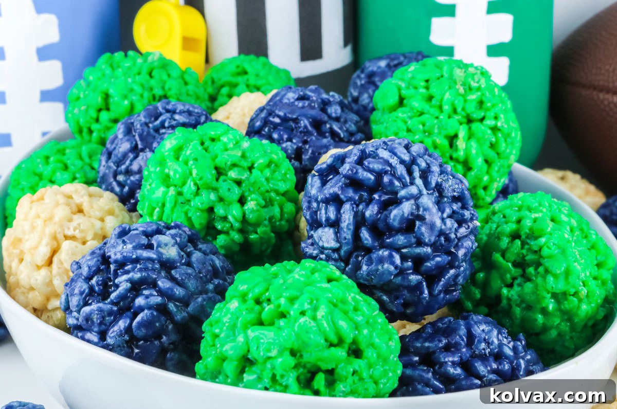 Closeup on a white bowl filled with Seattle Seahawks Rice Krispie Bites, showcasing the team's navy, green, and white colors.