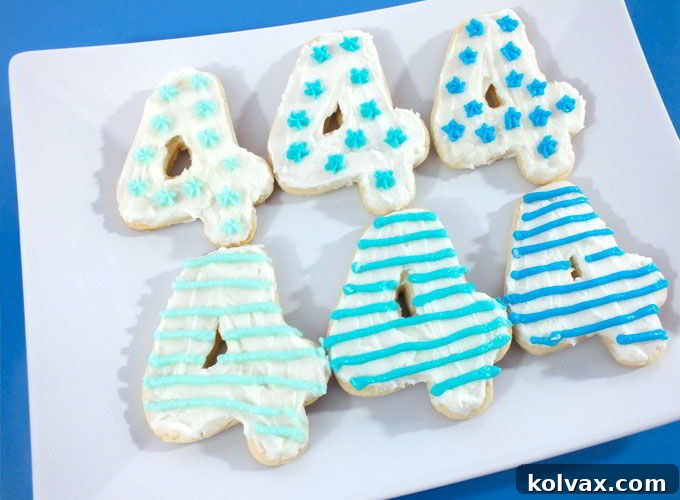 Plate of '4' shaped cookies decorated with ombre blue frosting