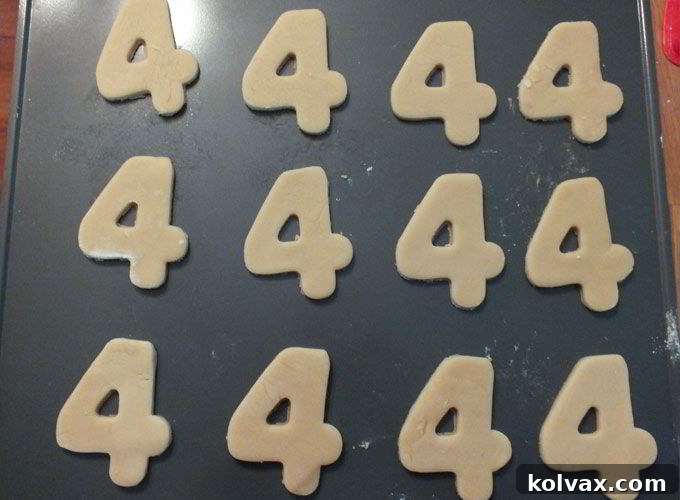 Sugar cookie dough cut into shapes, ready for baking in the oven