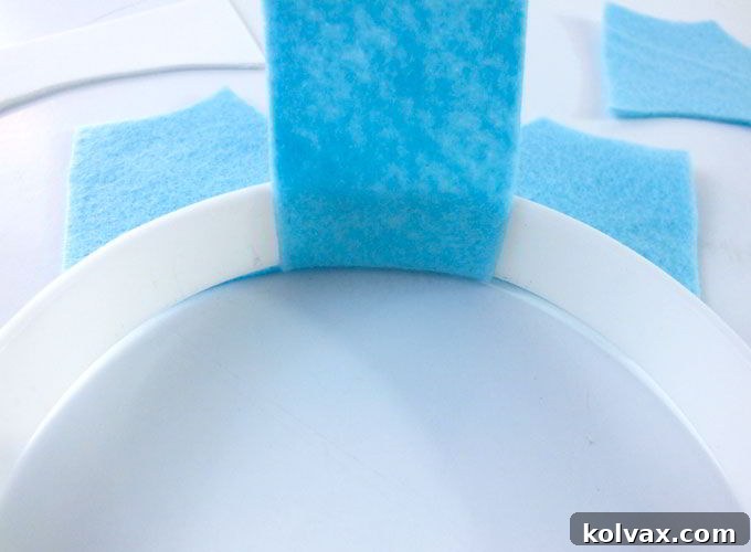 Close-up view of the front crown piece being securely glued to the headband, showing the tab wrapping around.