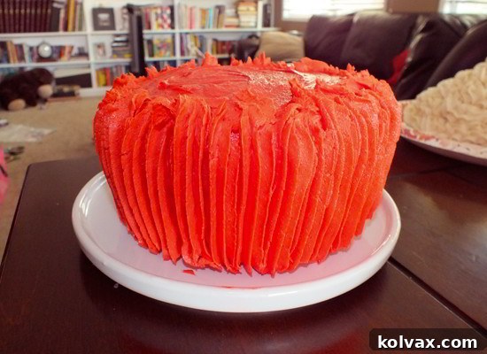 Mickey Mouse Celebration Cupcake Cake 3 Detail of the bottom half of the Mickey Mouse Cupcake Cake, beautifully frosted with vibrant red buttercream using vertical stripes.