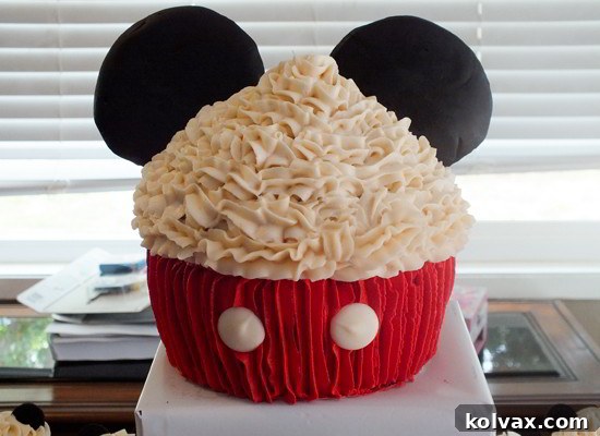 Mickey Mouse Celebration Cupcake Cake 7 The completed Mickey Mouse Cupcake Cake, featuring black modeling chocolate ears, ready to be the star of any birthday party.