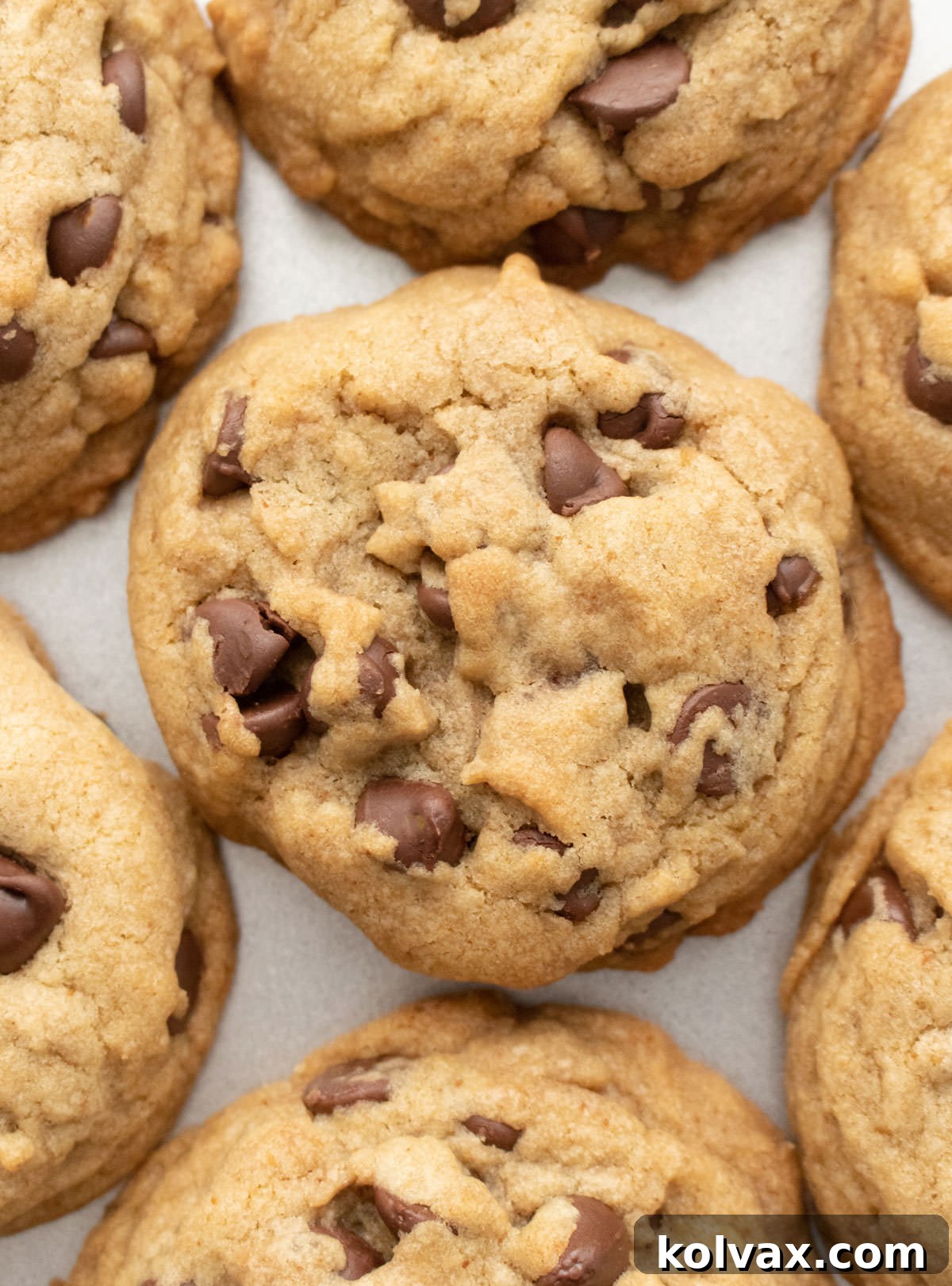 Nutty Brown Butter Chocolate Chip Perfection 6 Closeup on a flat batch of perfectly baked brown butter chocolate chip cookies on a silver cookie sheet, ready to be enjoyed.
