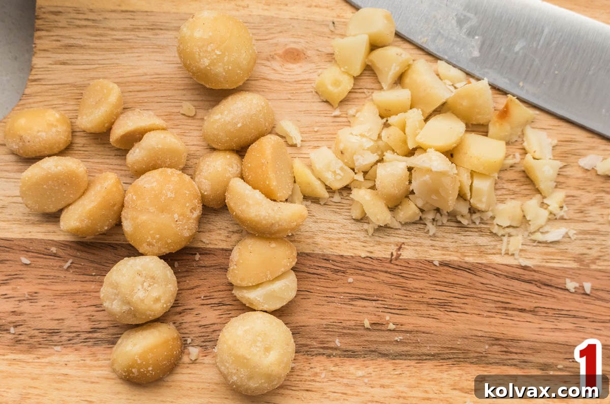 Macadamia Nuts on a cutting board with a knife.
