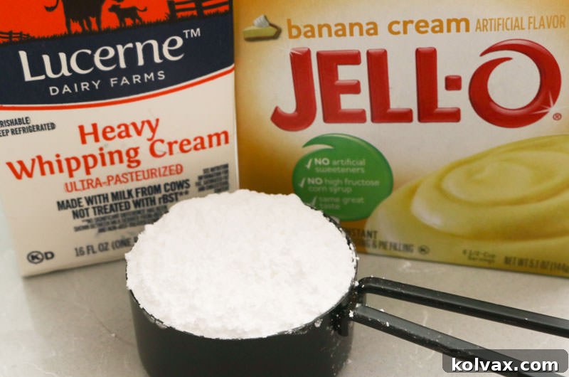 A selection of ingredients needed to make homemade Banana Whipped Cream Frosting: heavy whipping cream, banana cream pudding mix, and powdered sugar