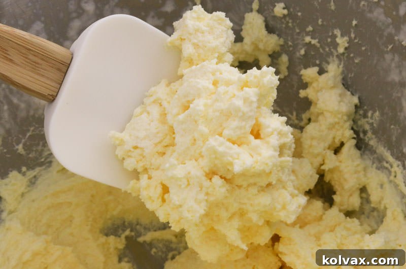 A spoonful of smooth and creamy Banana Whipped Cream Frosting, ready to be spread