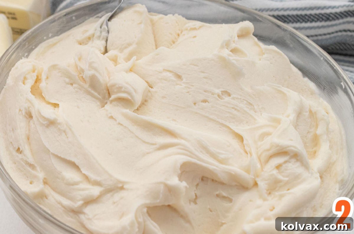 Closeup on a clear glass bowl filled with our signature Homemade Buttercream Frosting, ready for coloring.