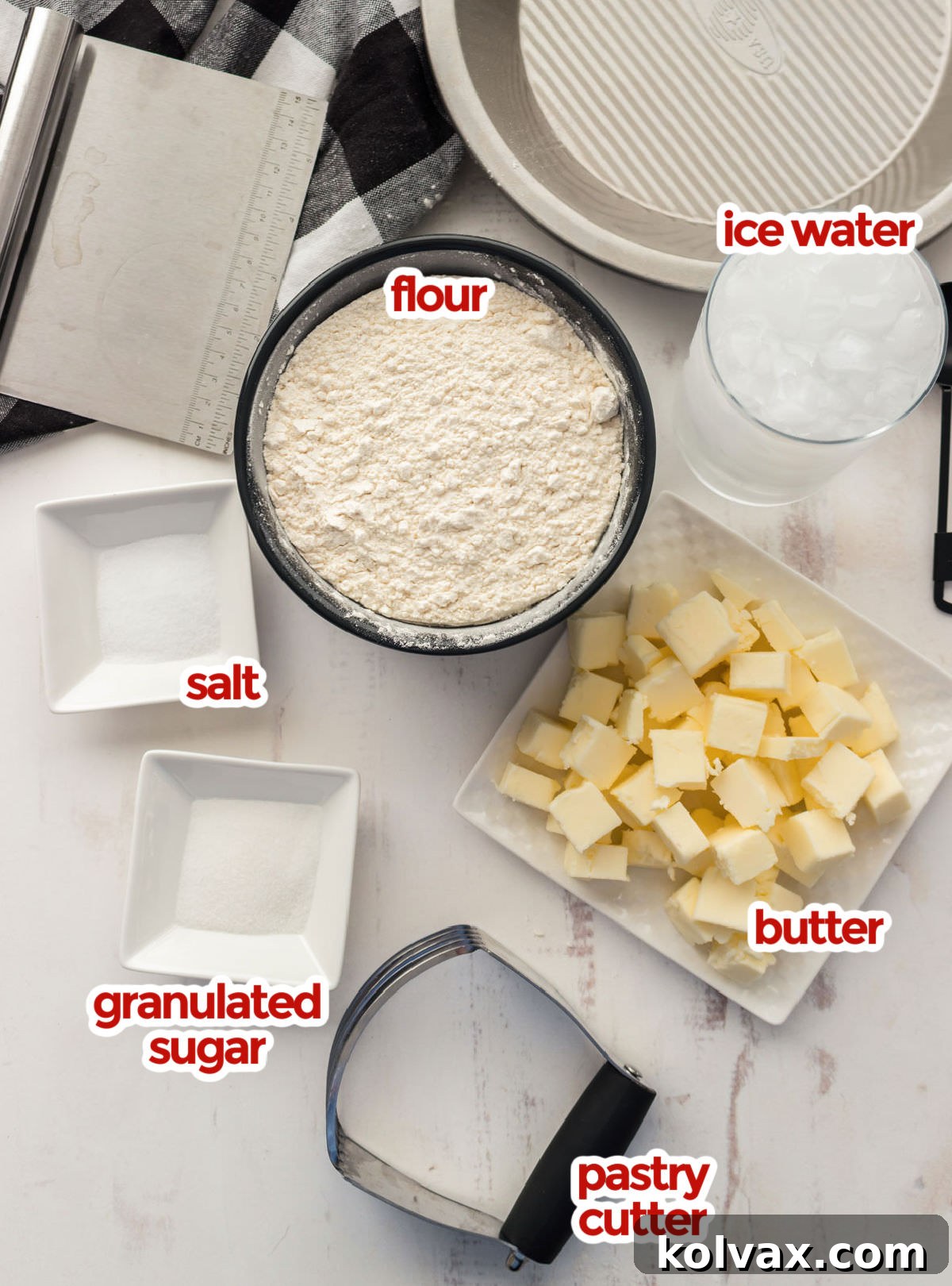 Ingredients needed to make a Homemade Pie Crust including flour, salt, sugar, butter and ice water. Each component is crucial for a flaky, tender dough.