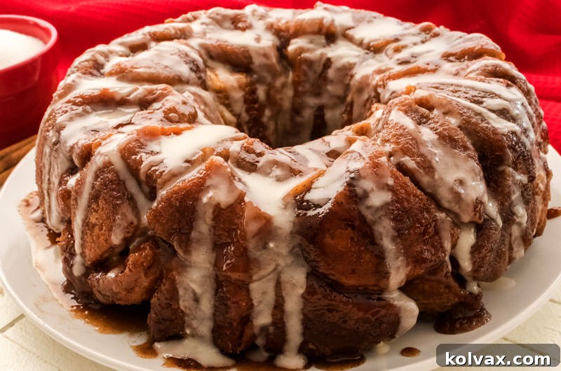 A beautifully baked Homemade Monkey Bread, golden brown and glistening with caramel and icing, ready to be pulled apart.