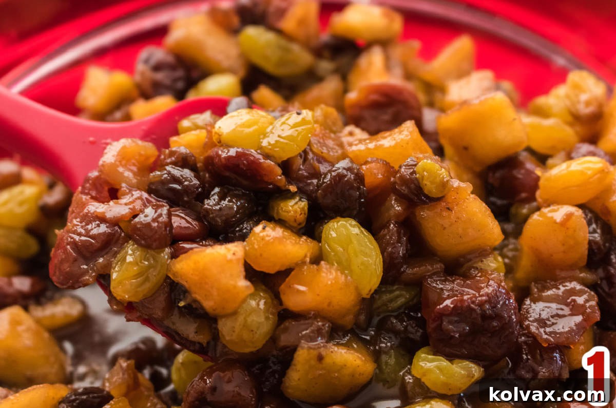 Bite-sized Festive Mince Pies 4 Closeup on a glass bowl filled with rich, dark Homemade Mincemeat.
