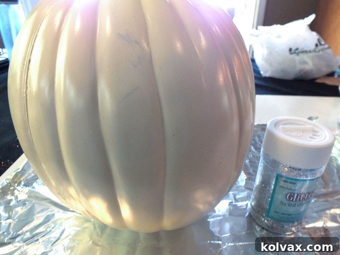 Getting ready to glitter a pumpkin with Mod Podge