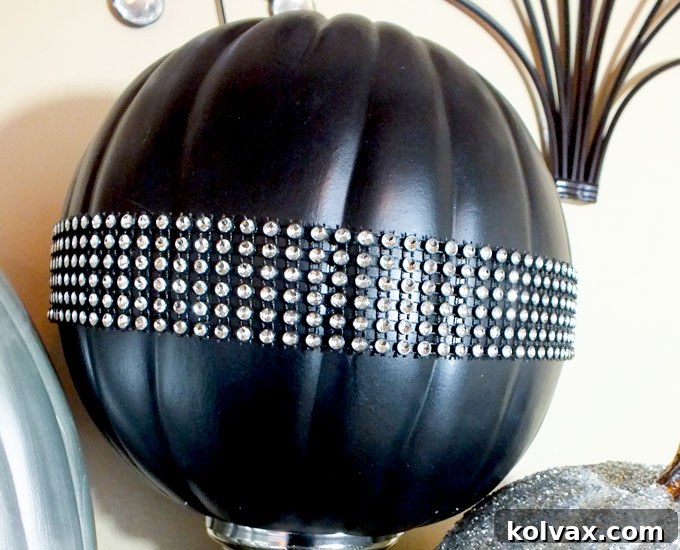 Black pumpkin adorned with dazzling rhinestone ribbon